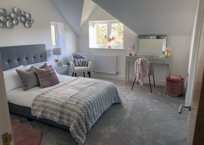 Bedroom home staging and interior design with bed and dressing table