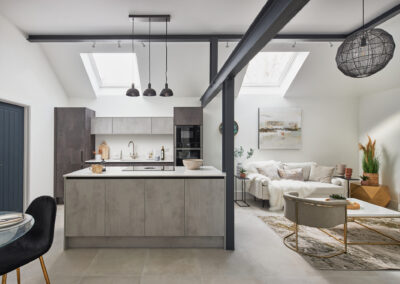 Professionally staged home by Beau Property Home Staging. Show home kitchen/lounge area, featuring several plants, ornaments, kitchenware & decorative lighting